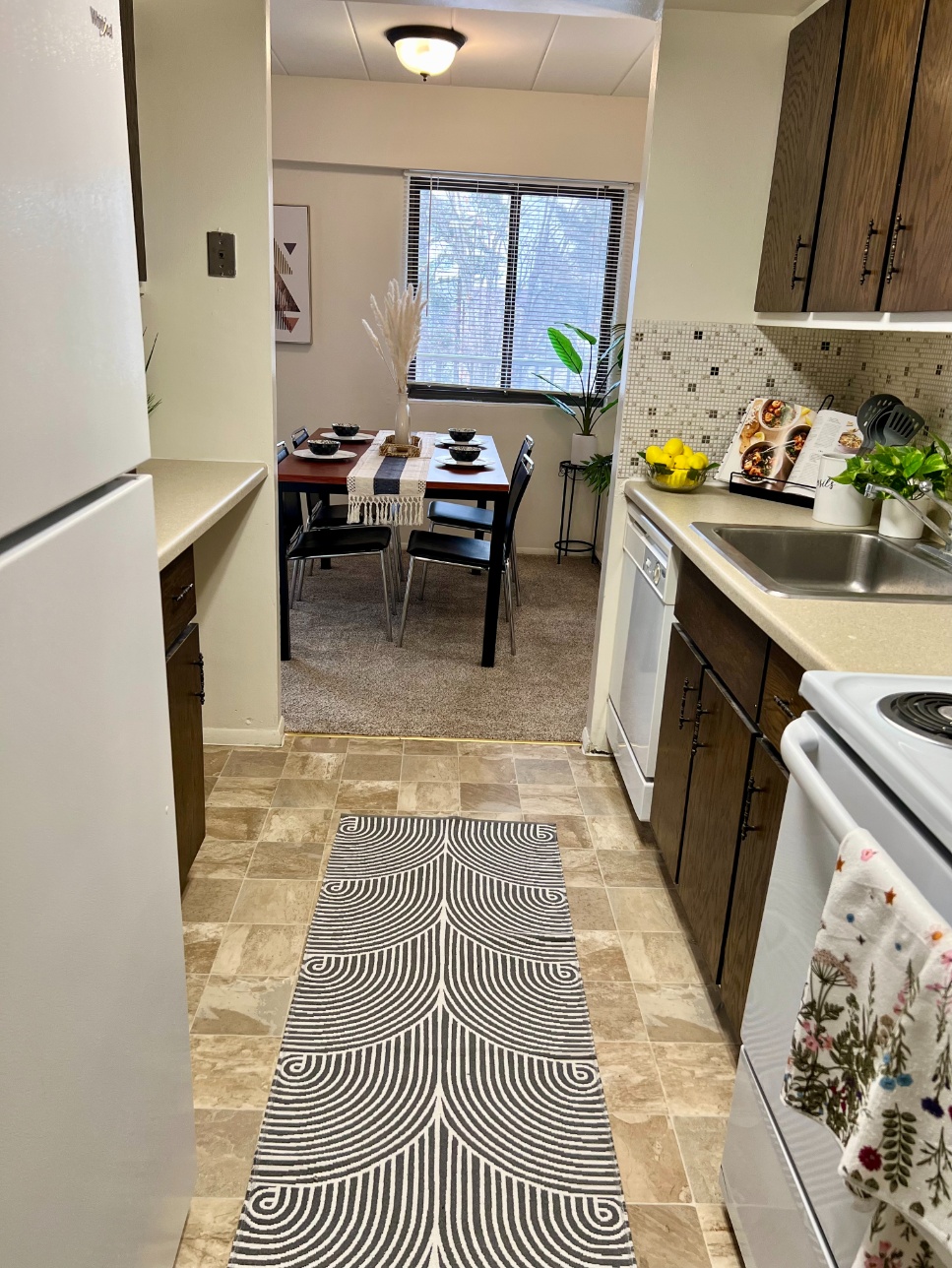 Galley kitchen and dining area of an apartment home at Parkway Plaza Galley kitchen and dining area of an apartment home at Parkway Plaza